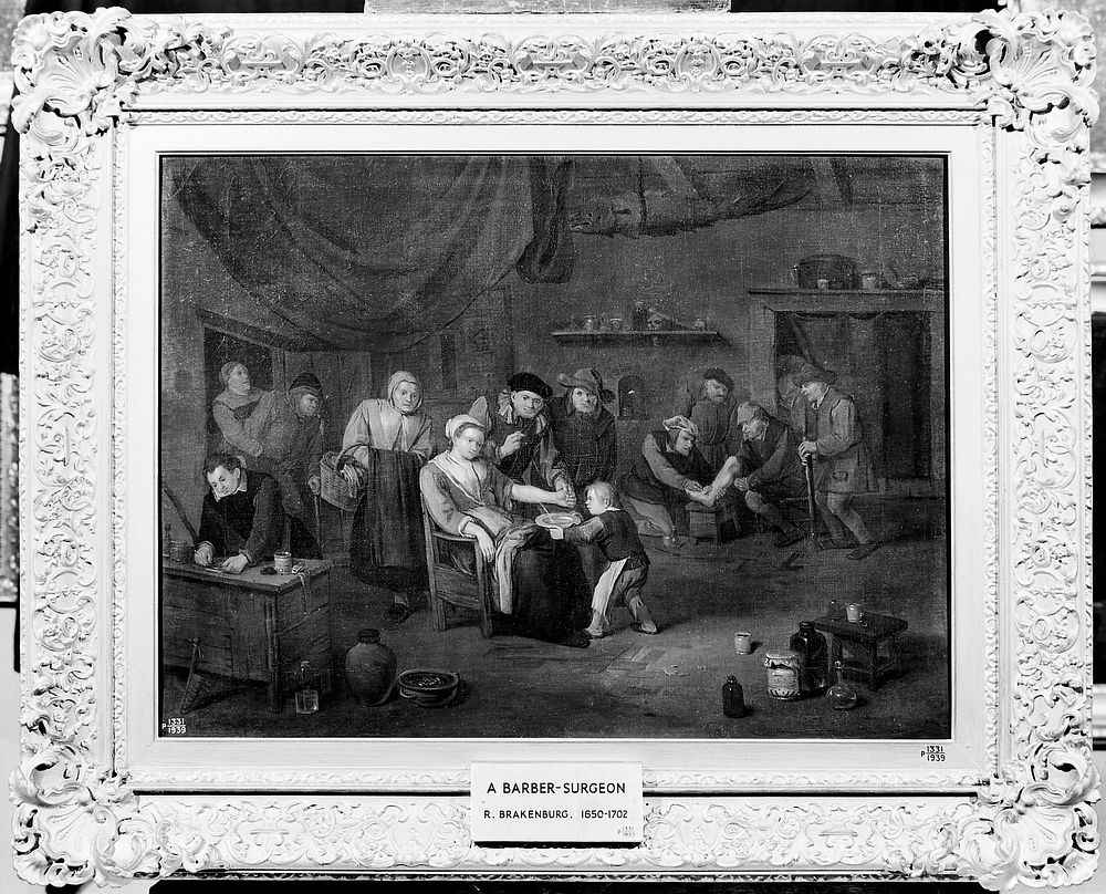 Interior of a surgery with a woman having blood let from the arm, a surgeon treating a man's injured foot, and other…