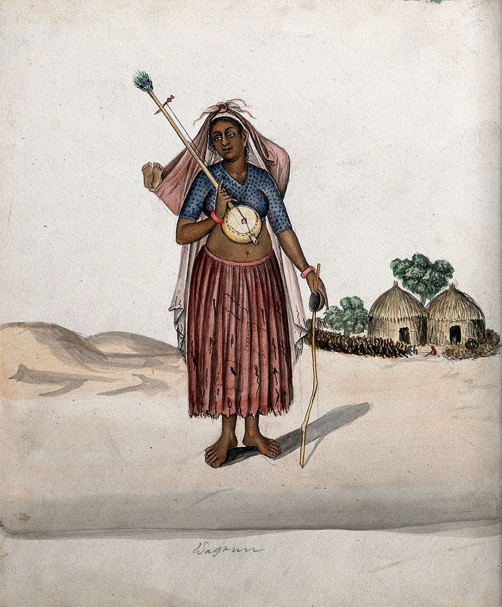 A village woman carrying a musical instrument in one hand, a stick with a small bowl in the other and a baby tied up in a…