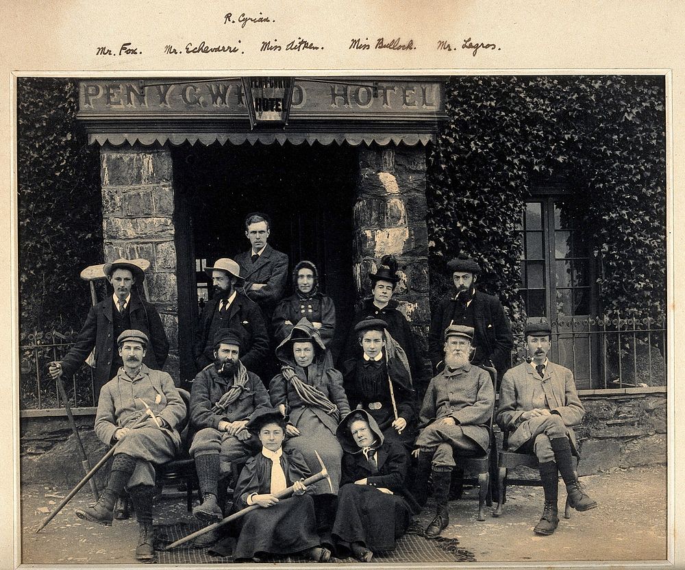 Pen-y-Gwryd, Wales: a mountaineering party seated outside Penygwryd Hotel, eight men, six women. Photograph by G.D. and A.…