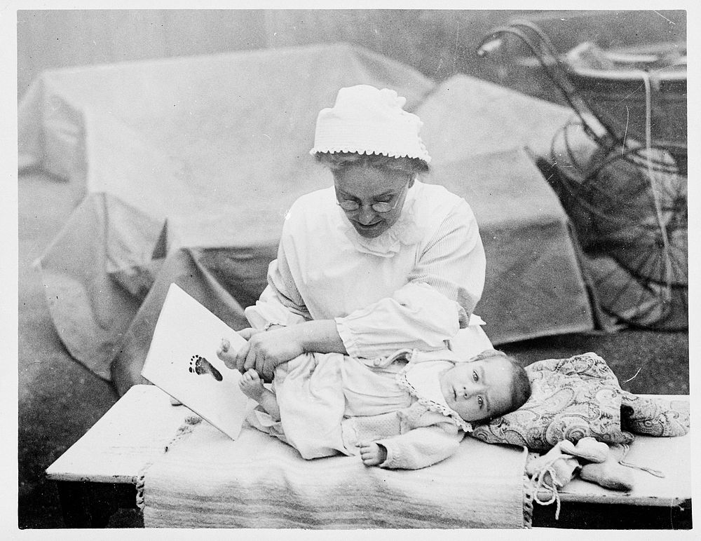 A baby's footprint being taken by a nurse for identification purposes. Photograph, 1910/1920.