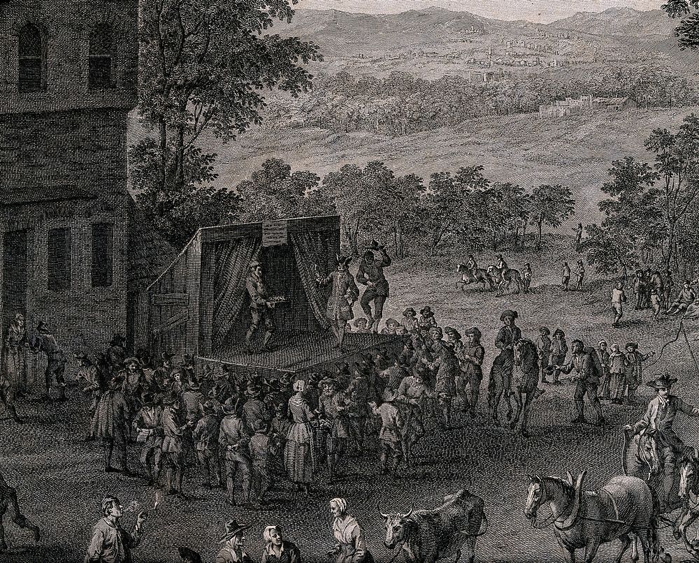 Crowds of people are gathered for a fete, a stage has been set up and actors are performing a play. Engraving by F.…
