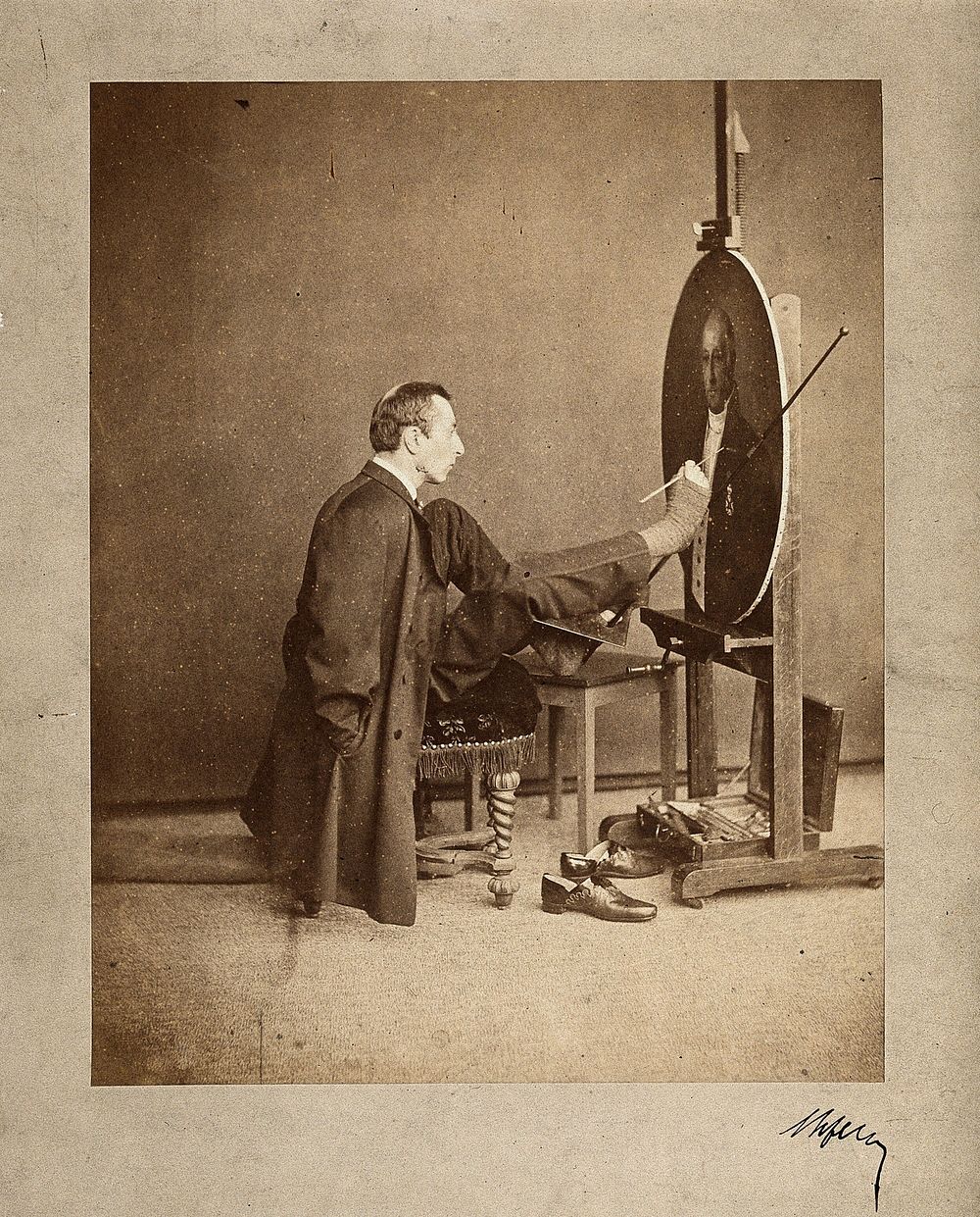 A man painting an oval portrait using his feet. Photograph by J. Dupont, c. 1870.