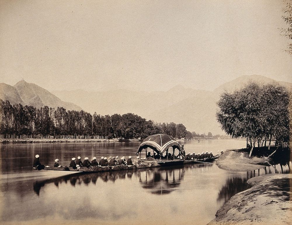 Srinagar, Kashmir: a large rowing boat proceeding along an inland waterway. Photograph by Samuel Bourne.