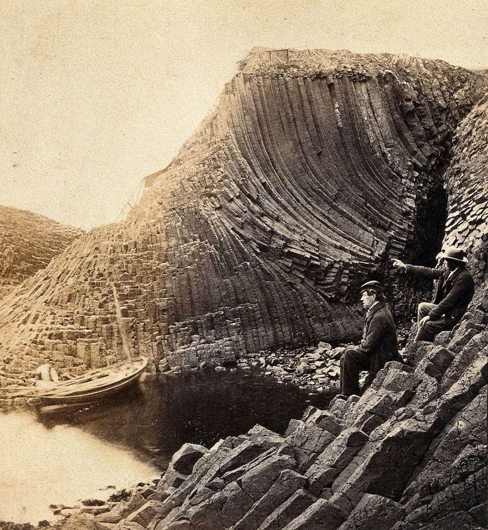 Staffa Island: two seated men admiring the basalt formations. Photograph, 18--.