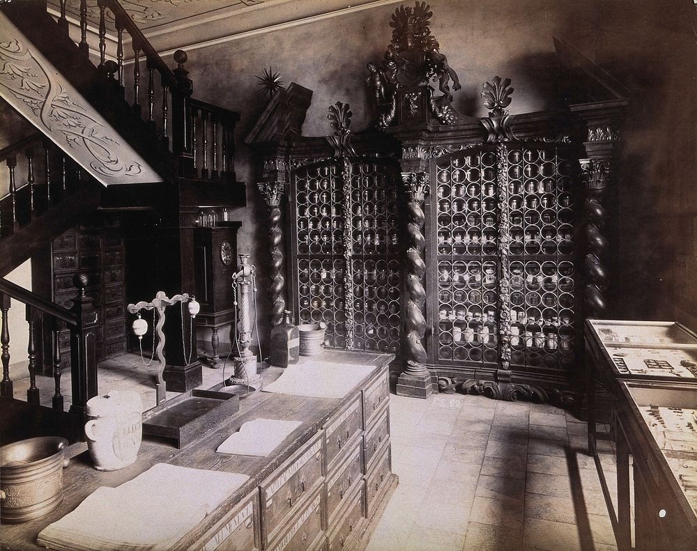 An eighteenth-century apothecary's shop with intricately carved wooden showcases; recreated for the Deutsches Museum in…