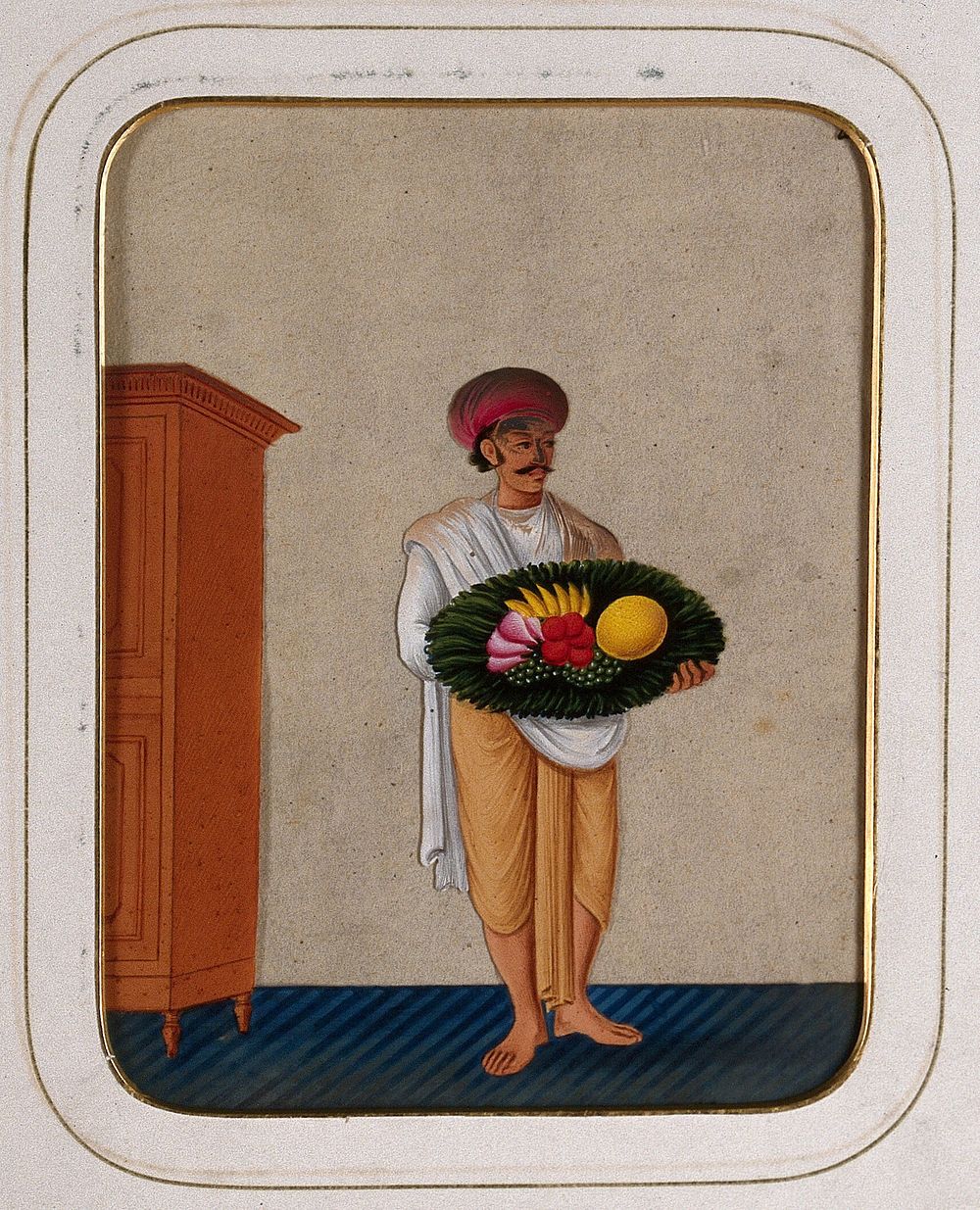 A servant holding a platter of fruit. Gouache painting on mica by an Indian artist.