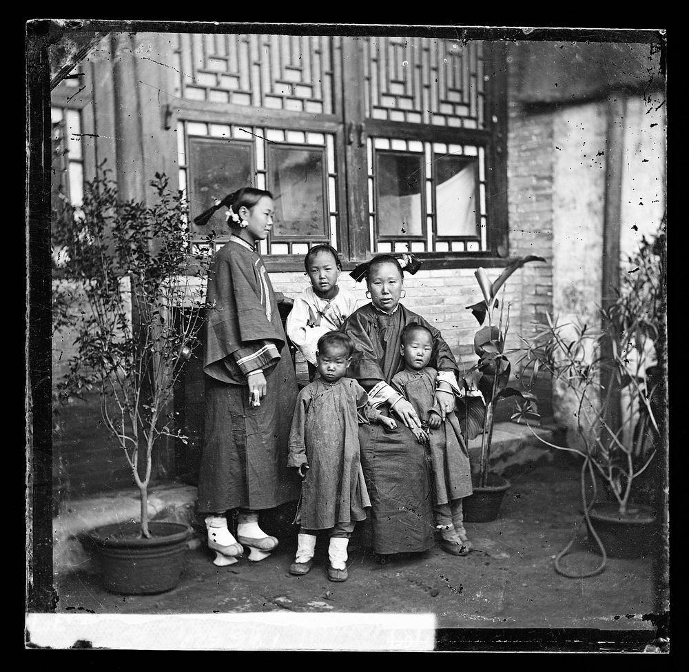 China: a Manchu lady with her daughter in-law and grandchildren, Beijing. Photograph by John Thomson, 1869.