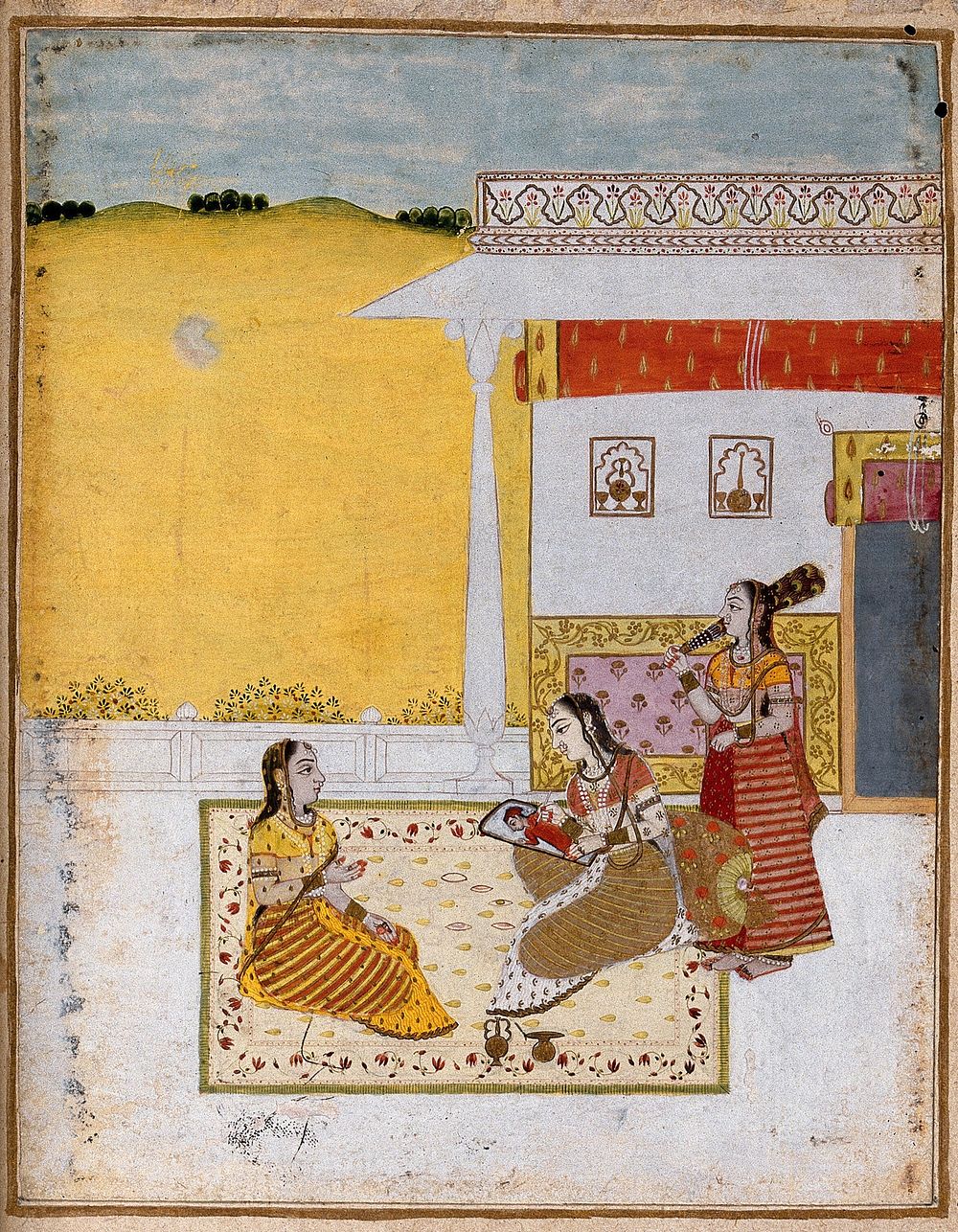 A woman sits on a carpet and paints a portrait of her lover watched by another woman. Gouache painting by an Indian painter.