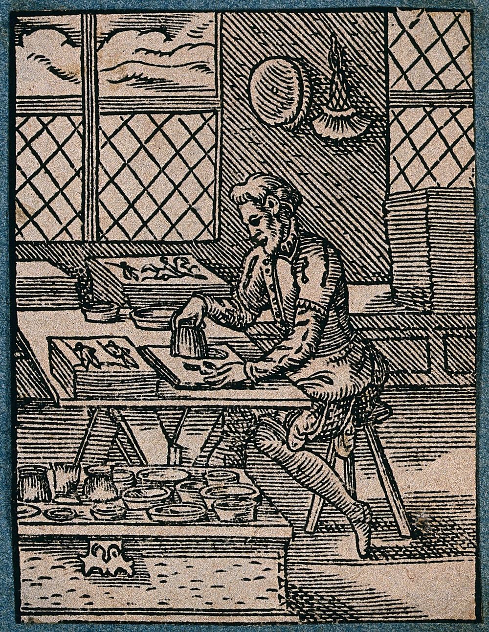A craftsman illuminating a document. Woodcut by J. Amman.