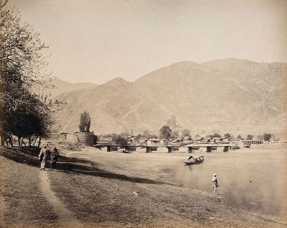 Baramula, Kashmir: a bridge over the river Jehlum with a town. Photograph by Samuel Bourne.