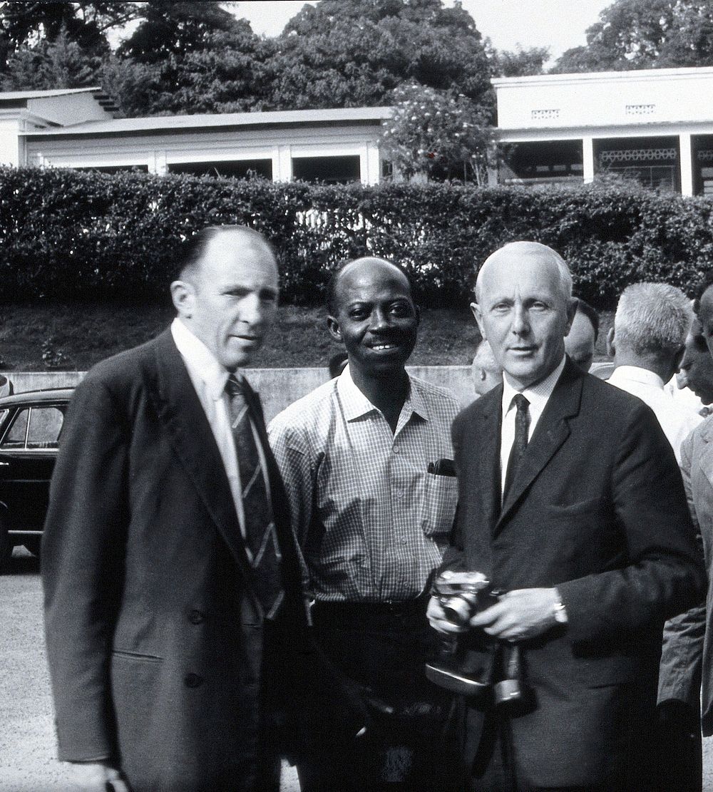 Three men including M.A. Wolfe. Photograph by L.J. Bruce-Chwatt.