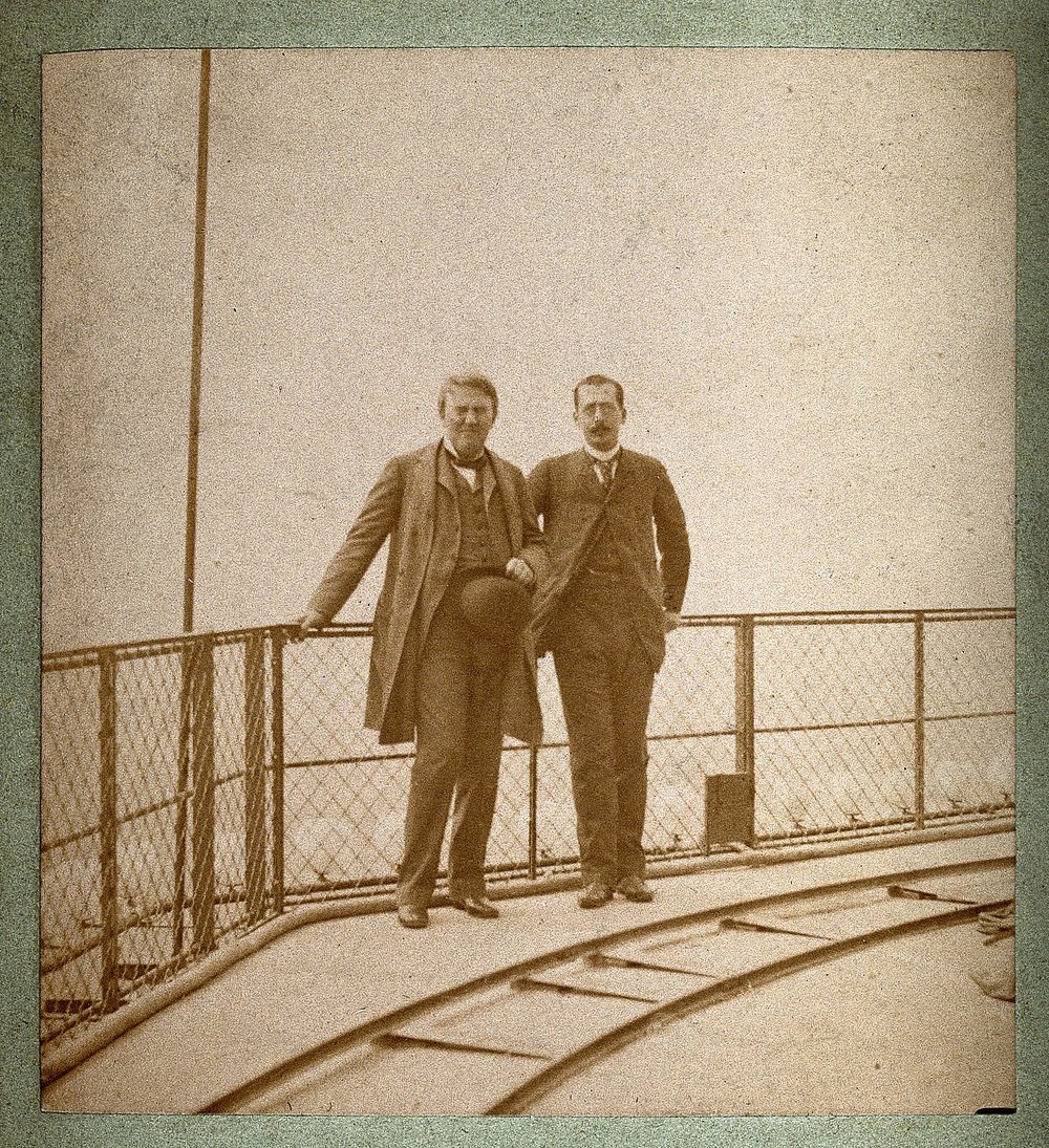 Eiffel Tower, Paris: Thomas Alva Edison and Adolphe Salles standing by railings on a platform of the tower. Photograph, 1889.