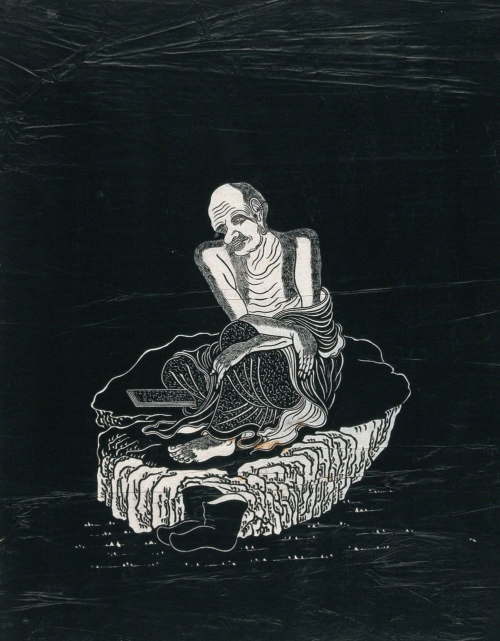 A Lohan (disciple of Buddha), seated on a rock, reading. Woodcut in the manner of an ink stone rubbing, China, 18--.