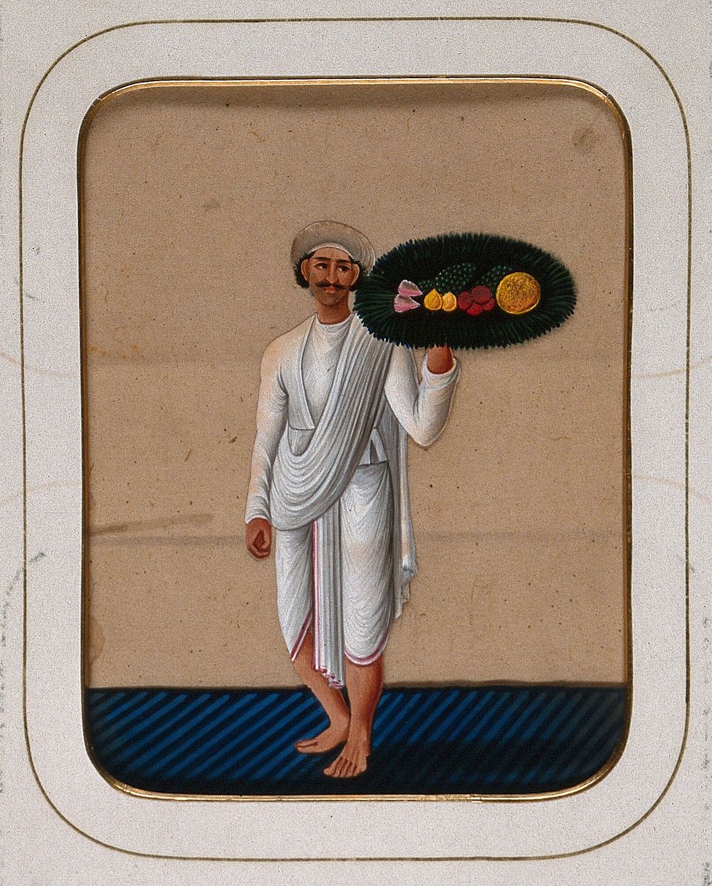A servant holding up a platter of fruit. Gouache painting on mica by an Indian artist.