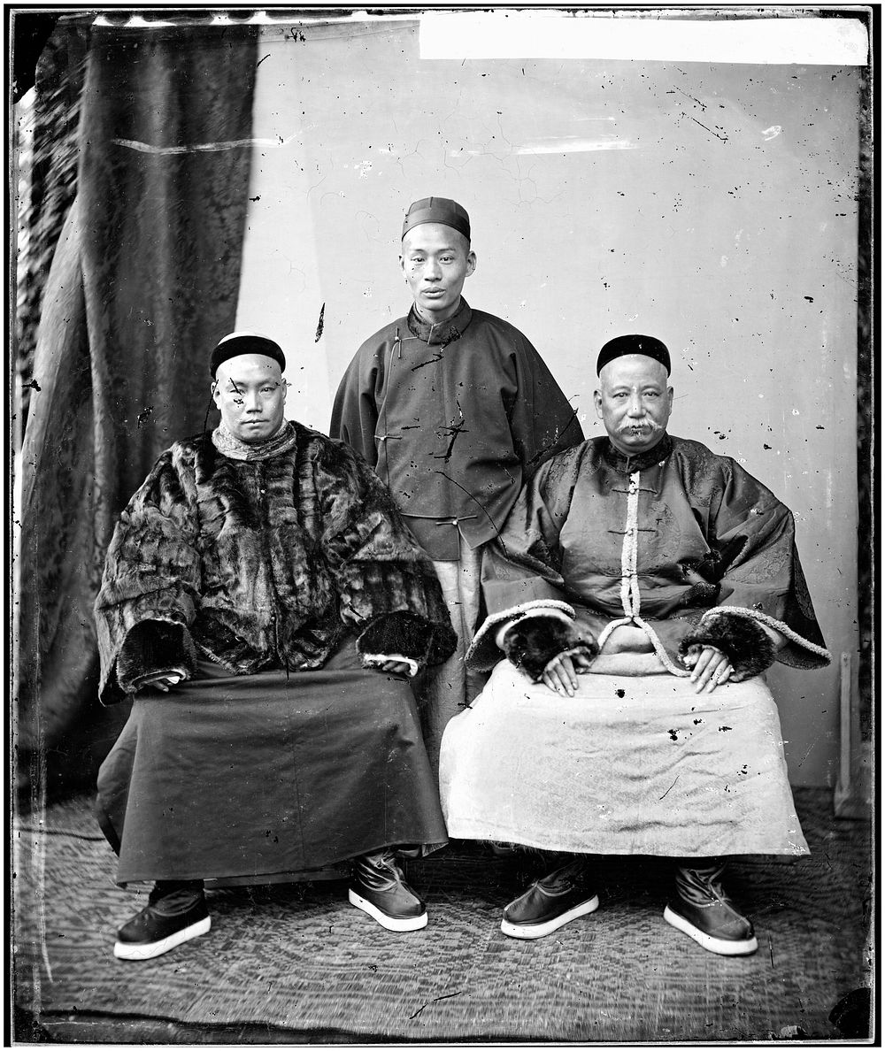 Canton, Kwangtung (Guangdong) province, China: three Chinese merchants. Photograph by John Thomson, 1869.