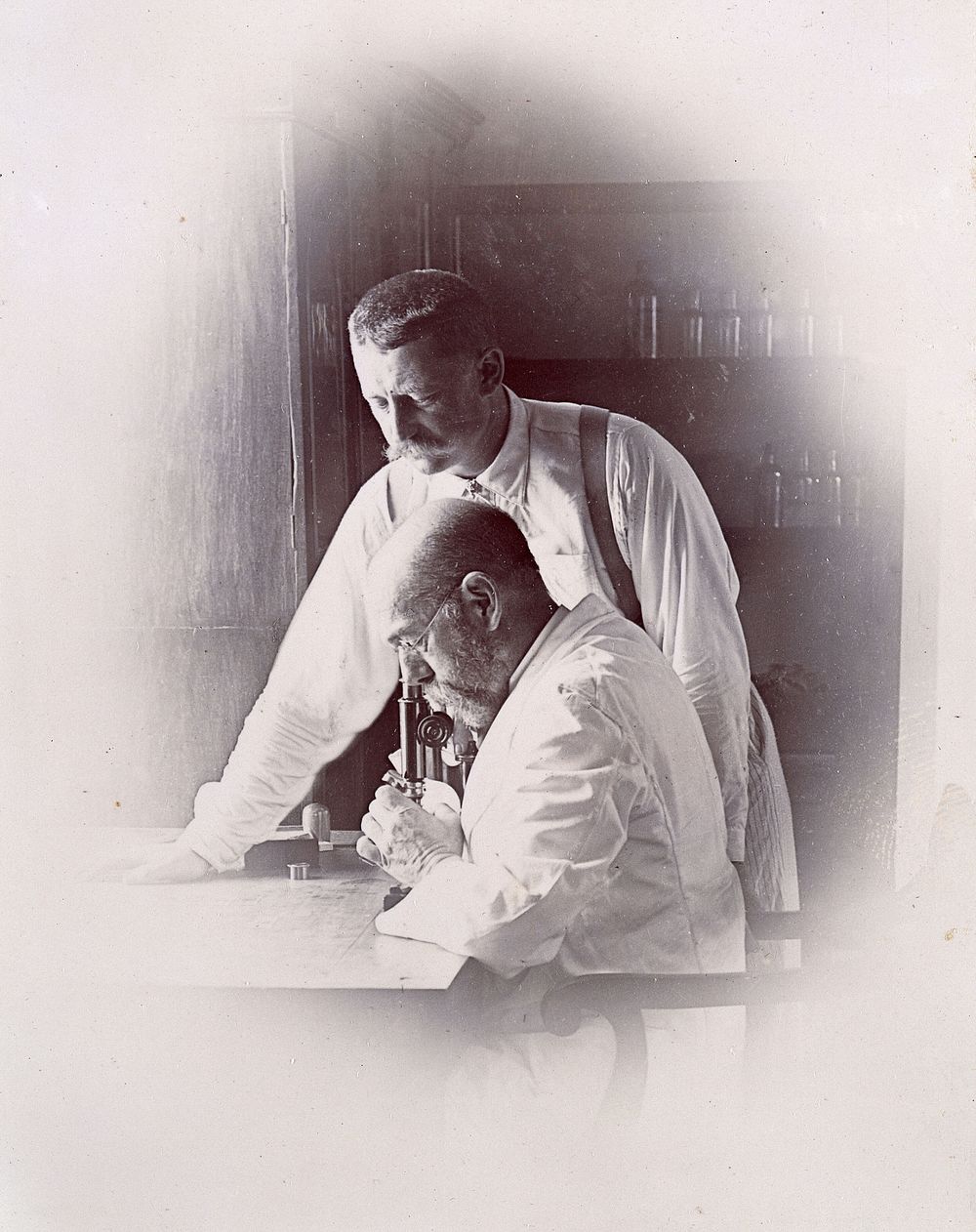 Robert Koch and Richard Pfeiffer working in a laboratory, investigating the plague in Bombay. Photograph attributed to…