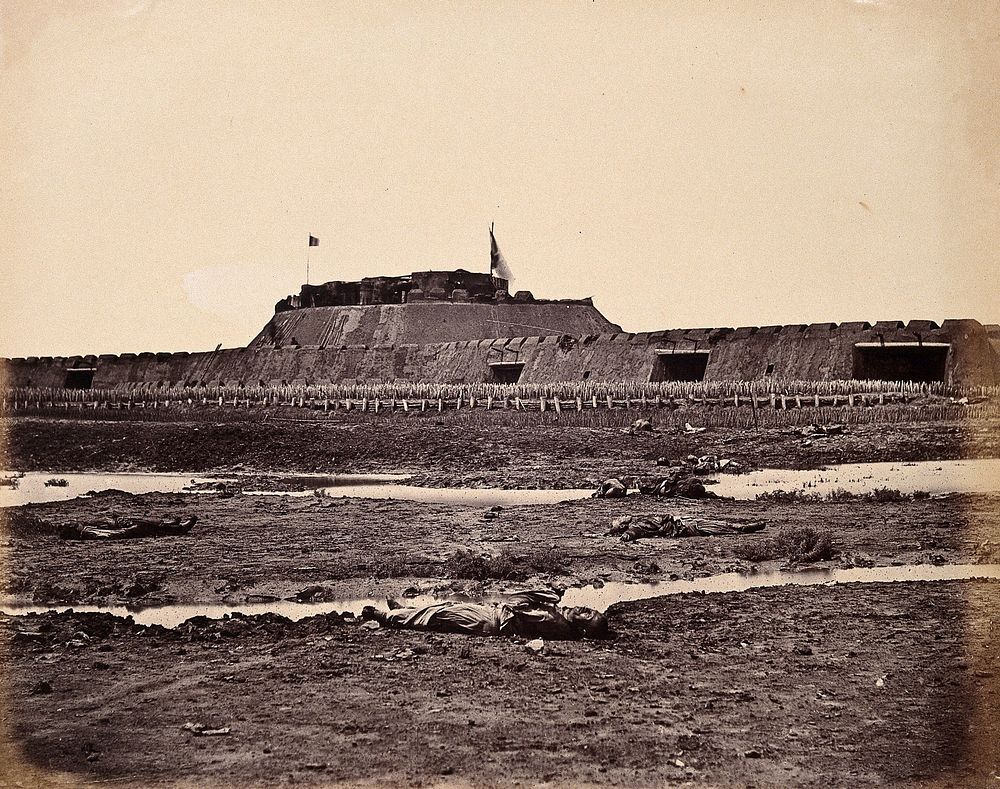 Taku, China: the North Fort bearing raised British and French flags; Chinese corpses in the foreground; on the day of the…