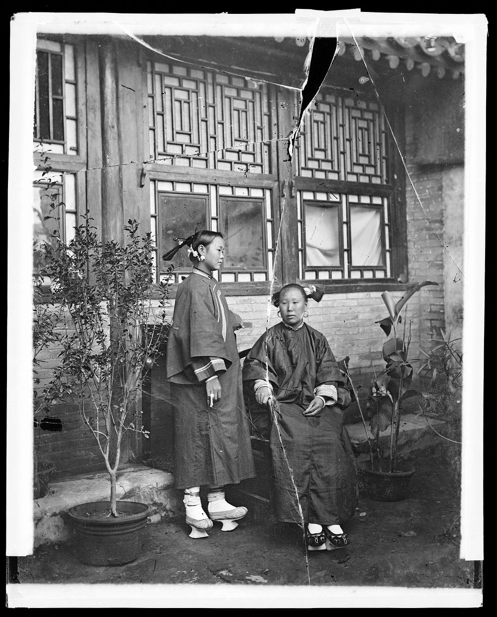 China: a Manchu lady with her daughter in-law, Beijing. Photograph by John Thomson, 1869.