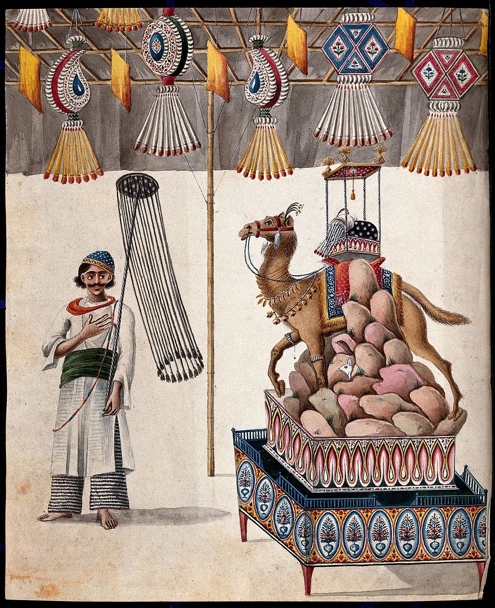 A man carrying a ceremonial object stands next to a tableau of rocks, a camel, decorated headgear and other animals set on…