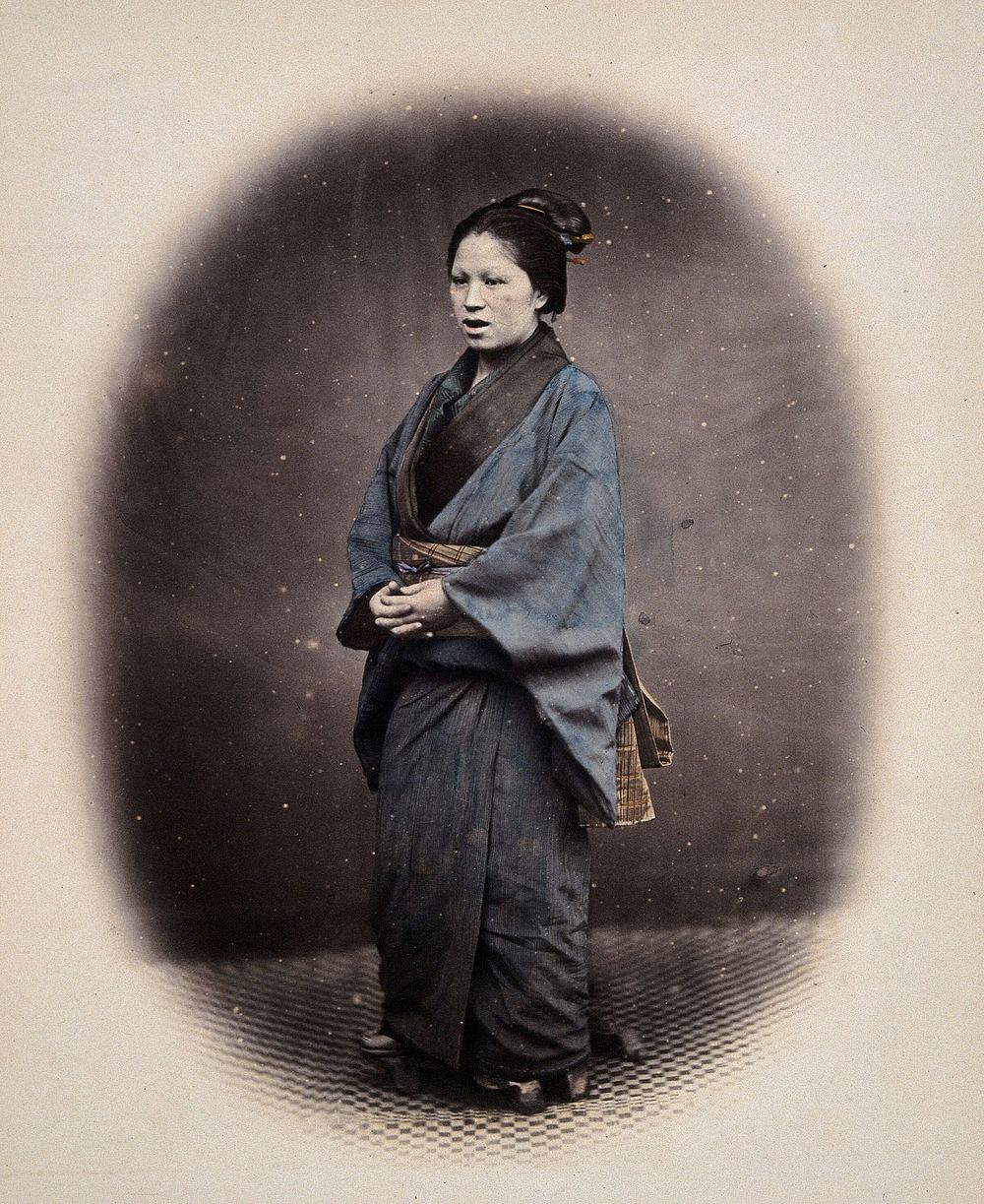 A Japanese married woman wearing traditional dress. Coloured photograph by Felice Beato, ca. 1870.