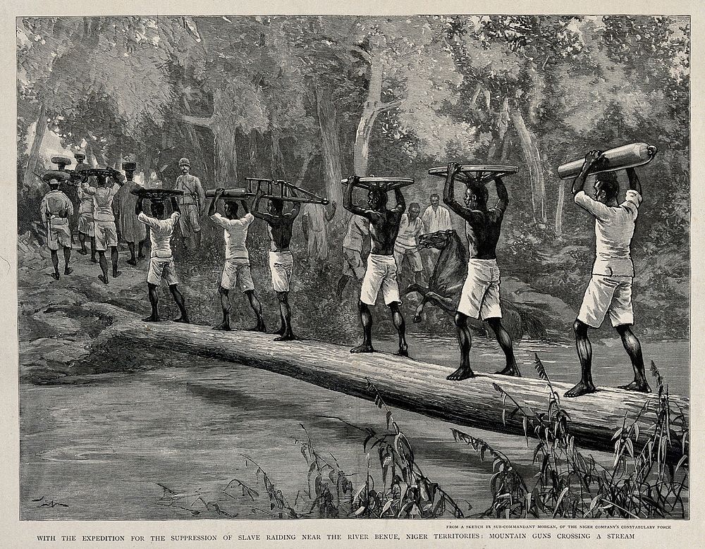 Nigerian porters carrying gun parts across the Benue river in a British expedition to suppress slavery. Wood engraving after…