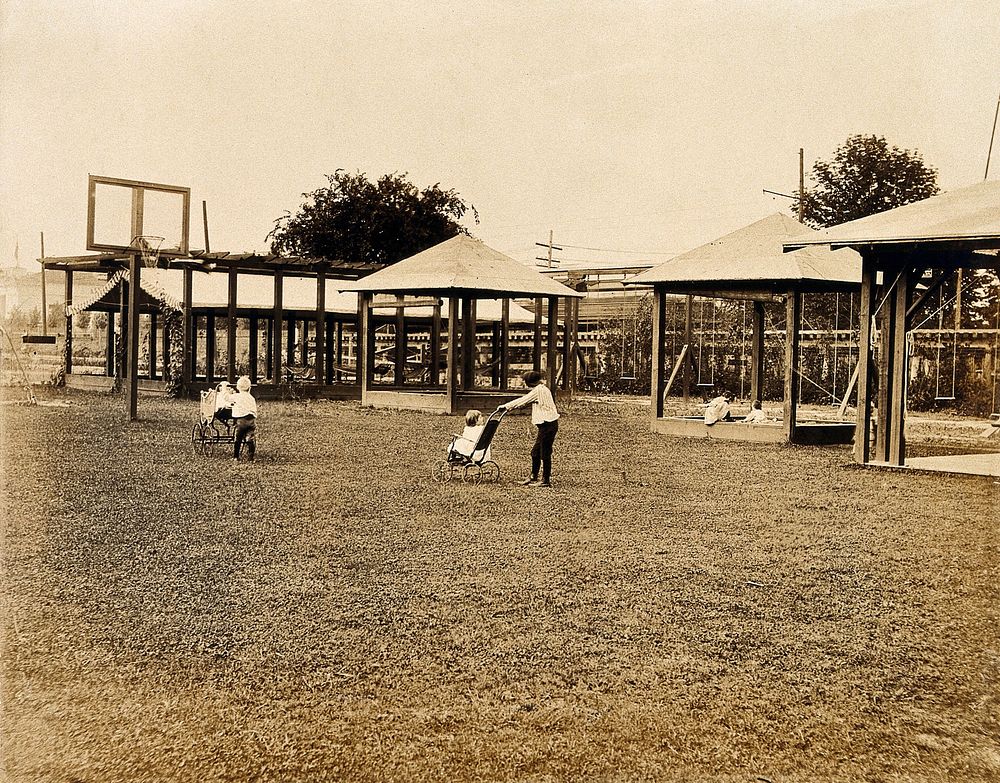 The 1904 World's Fair, St. Louis, Missouri: the children's creche: two children in pushchairs on the grass; swings and…