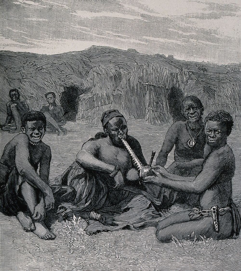 An African chief of the Barotsi tribe smoking his pipe which is held by a woman. Wood-engraving.