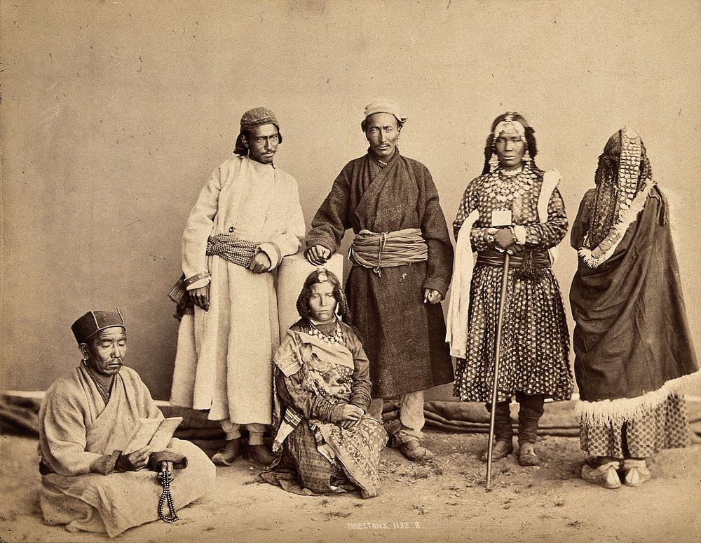 Tibetan men and women in traditional dress. Photograph, ca. 1900.