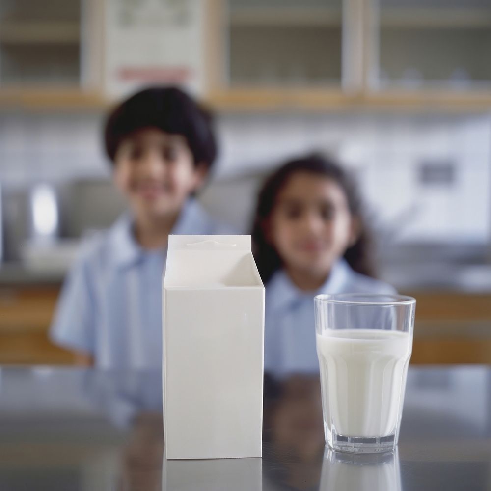 Milk carton sitting dairy table.