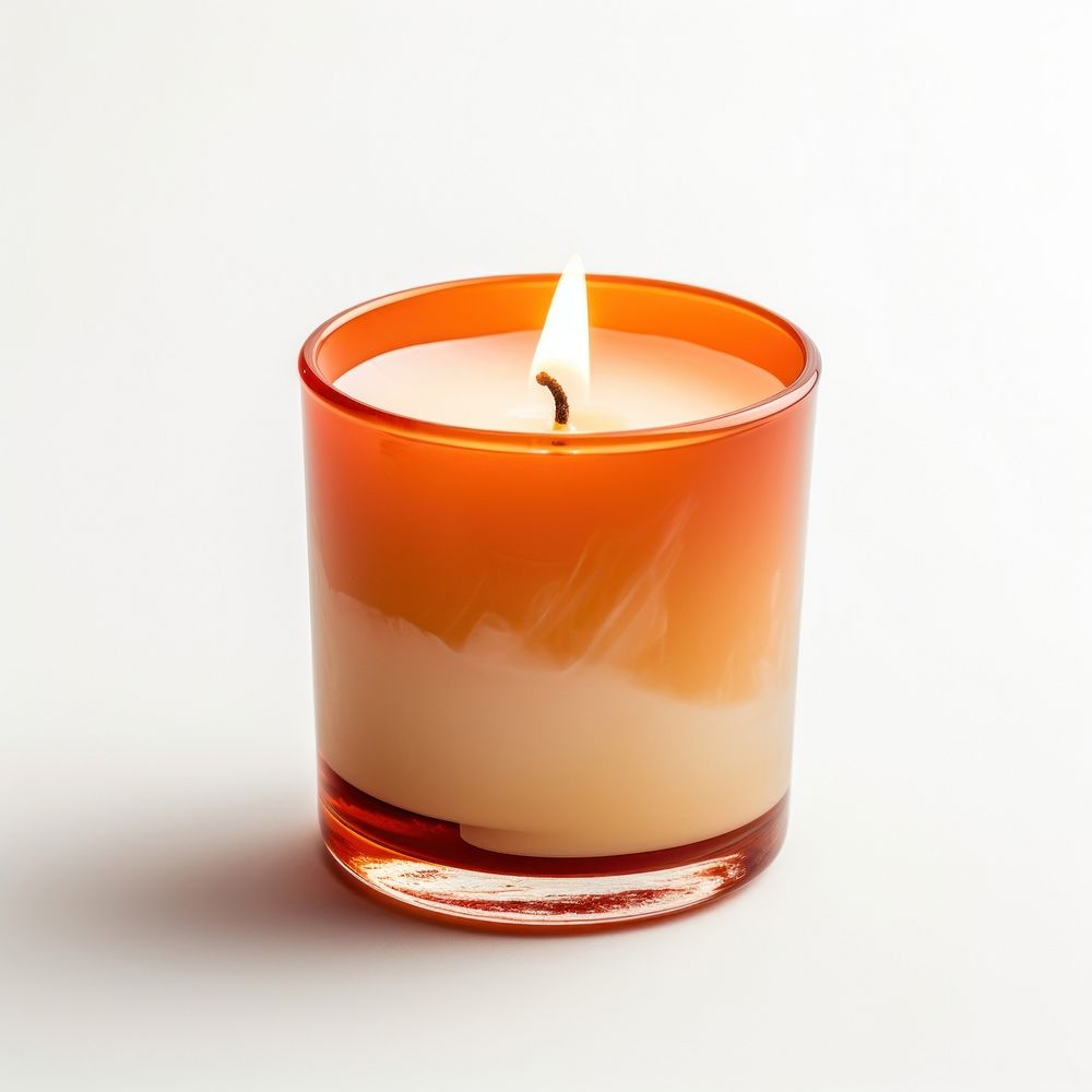 A burnt orange glass candle with blank white label fire white background refreshment.