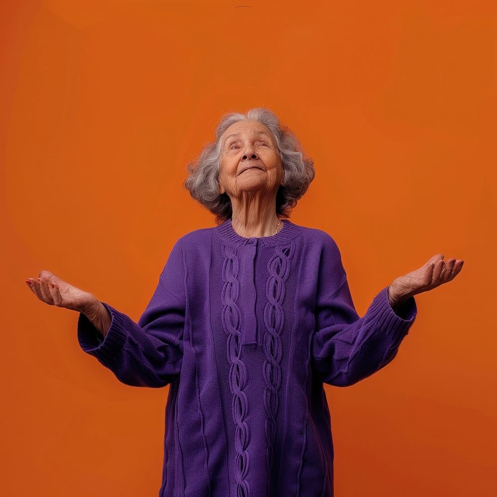 Old woman in purple sweater with her arms open adult retirement gesturing.