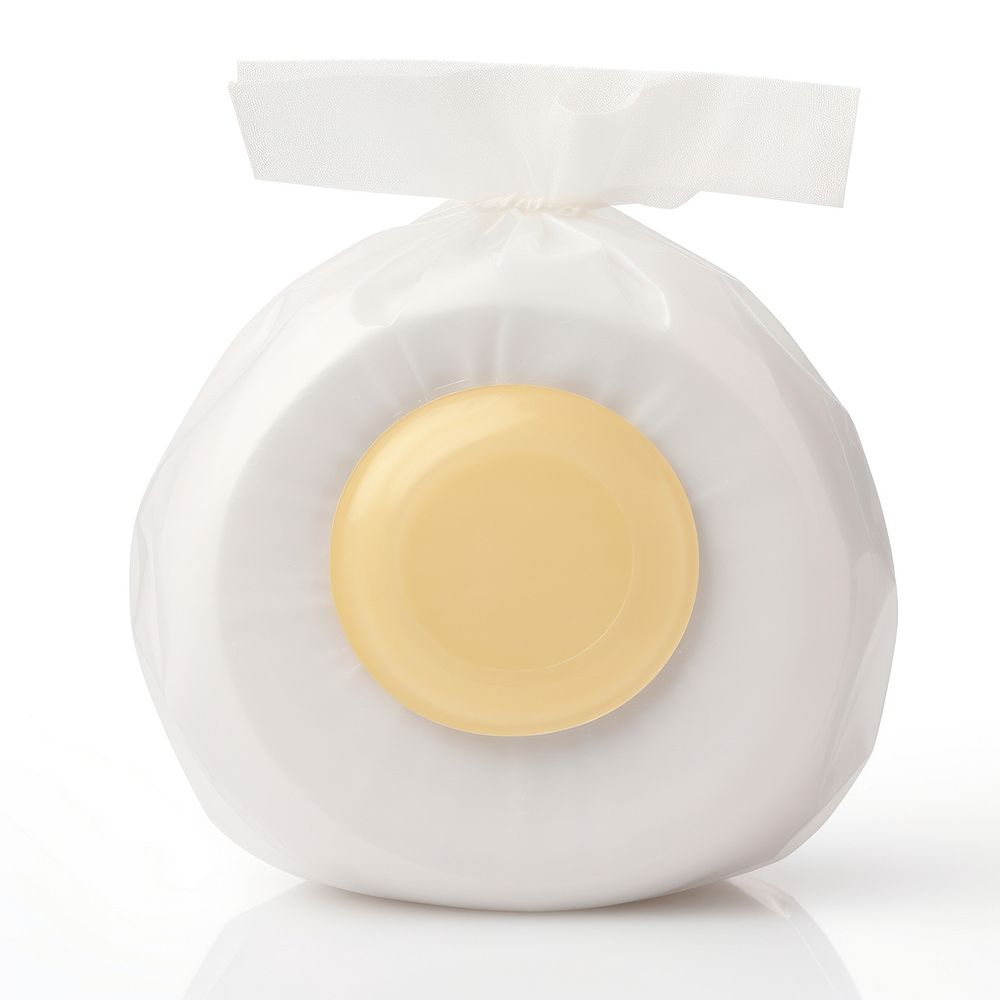 Round hotel soap in a blank white package egg white background lighting.
