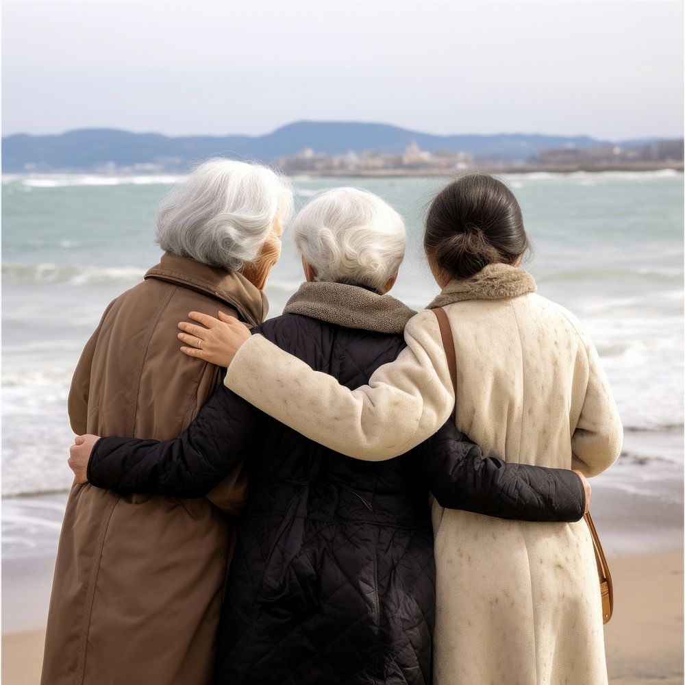 3 friends Japanese elderly sea outdoors hugging.