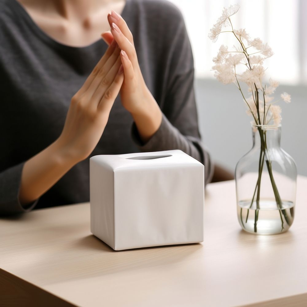 Tissue box packaging hand contemplation relaxation.