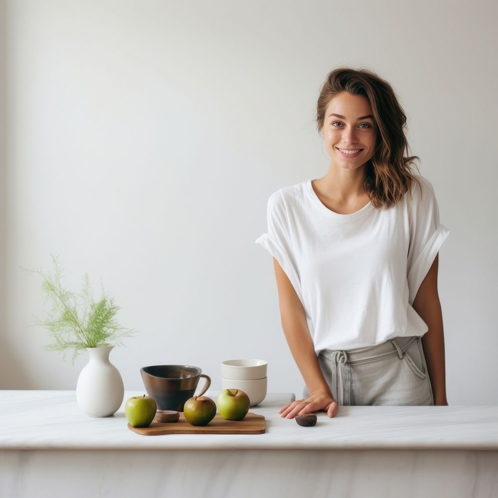 A happy woman standing in the kitchen portrait blouse sleeve.