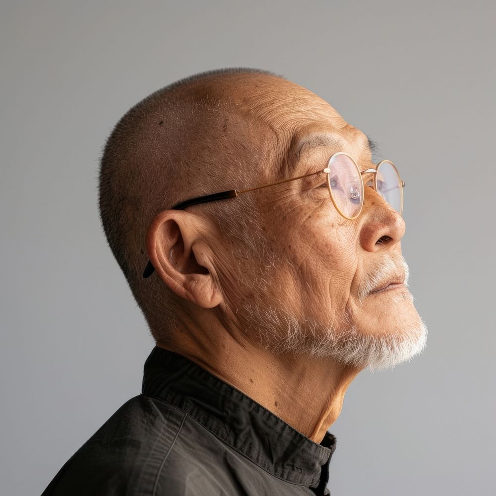Fashion art studio portrait of asian old man glasses adult contemplation.