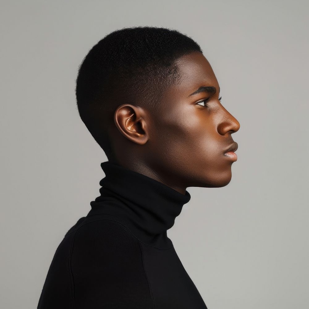 Fashion art studio portrait of Cool elegant black man in black turtleneck contemplation photography hairstyle.