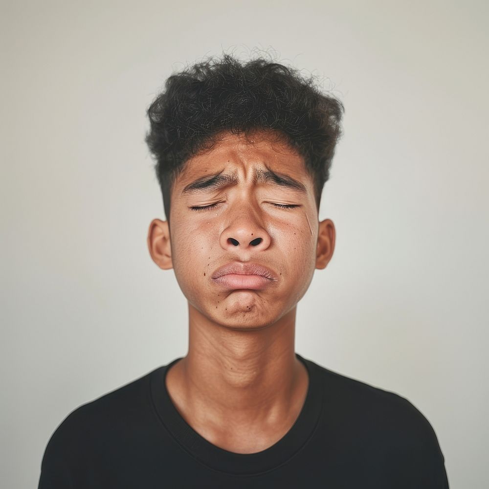 Thai teenage boy crying portrait photo face.