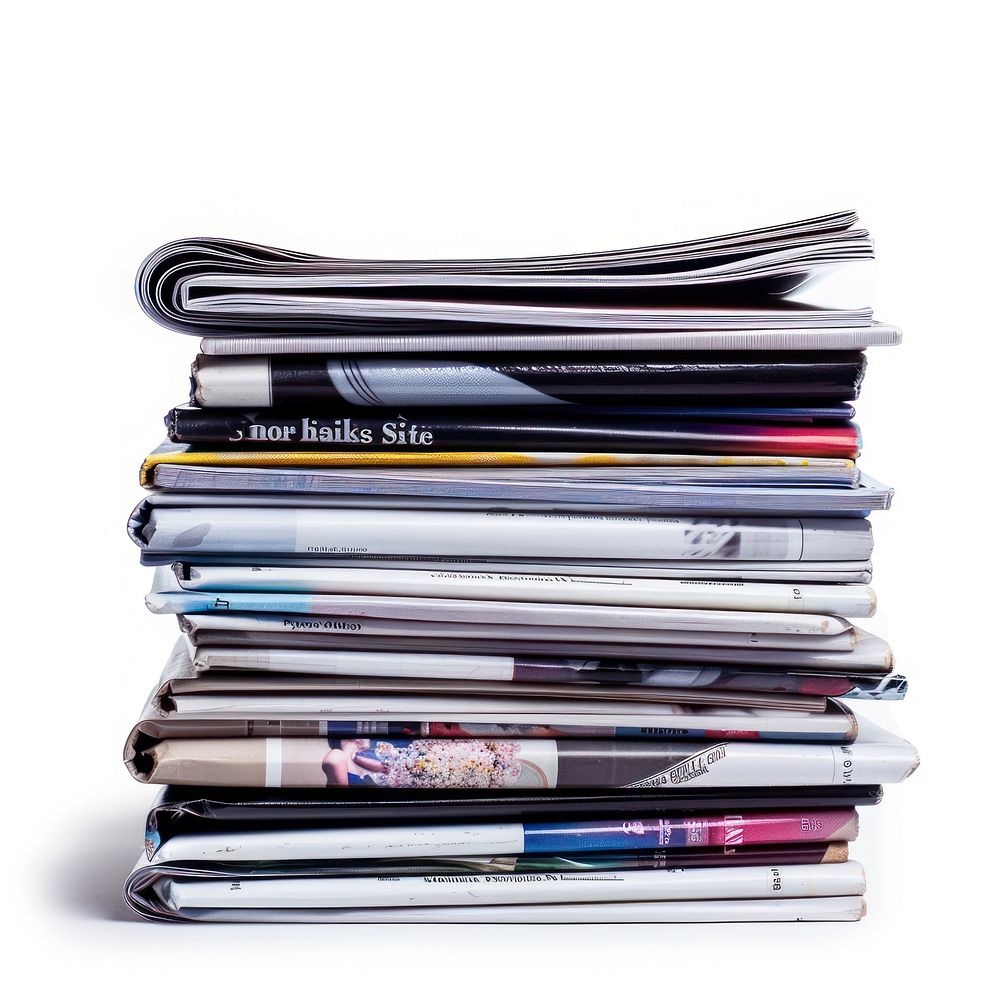 Stack of magazines newspaper text.