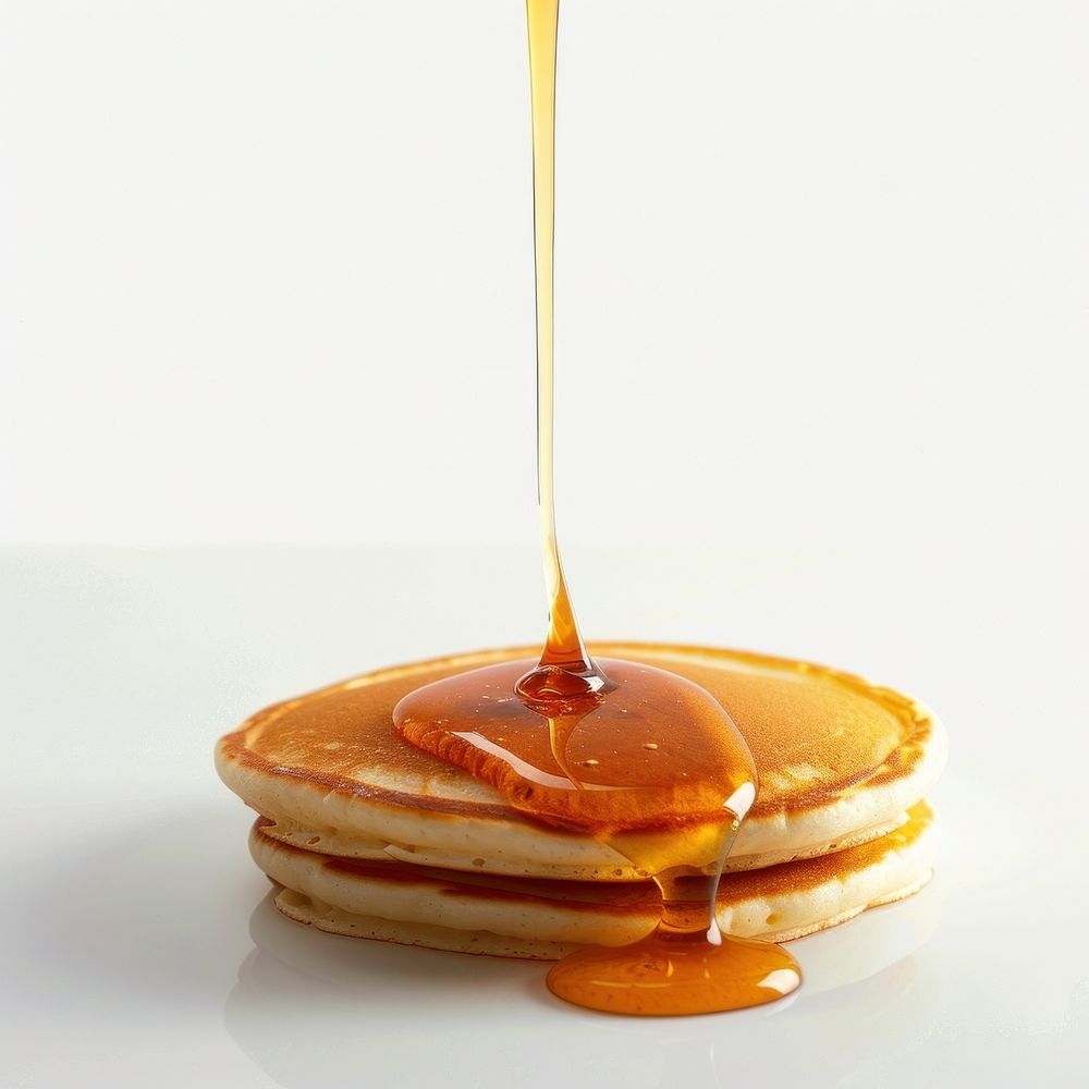 A drop of maple syrup was slowly dripping onto the pancake seasoning caramel dessert.