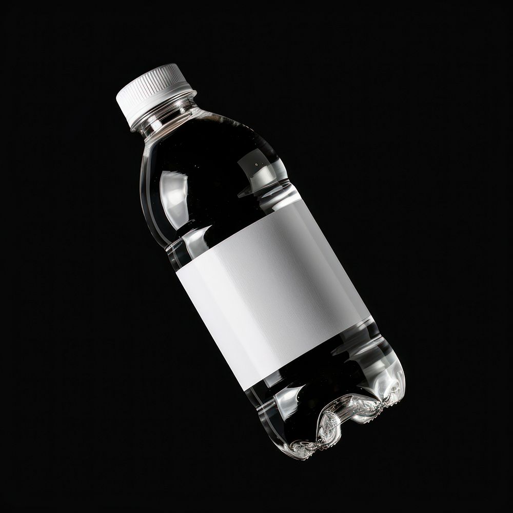Water bottle with white label black black background refreshment.