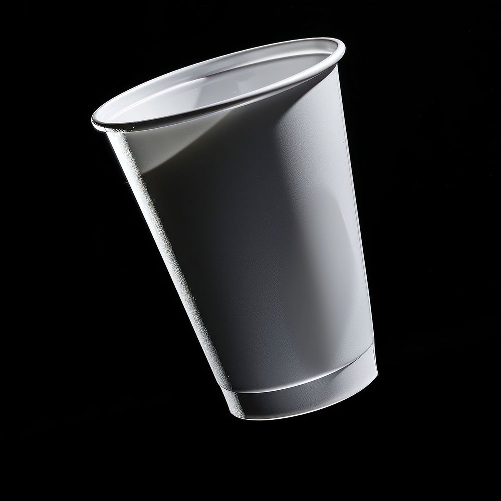Plastic cup with white label black black background refreshment.