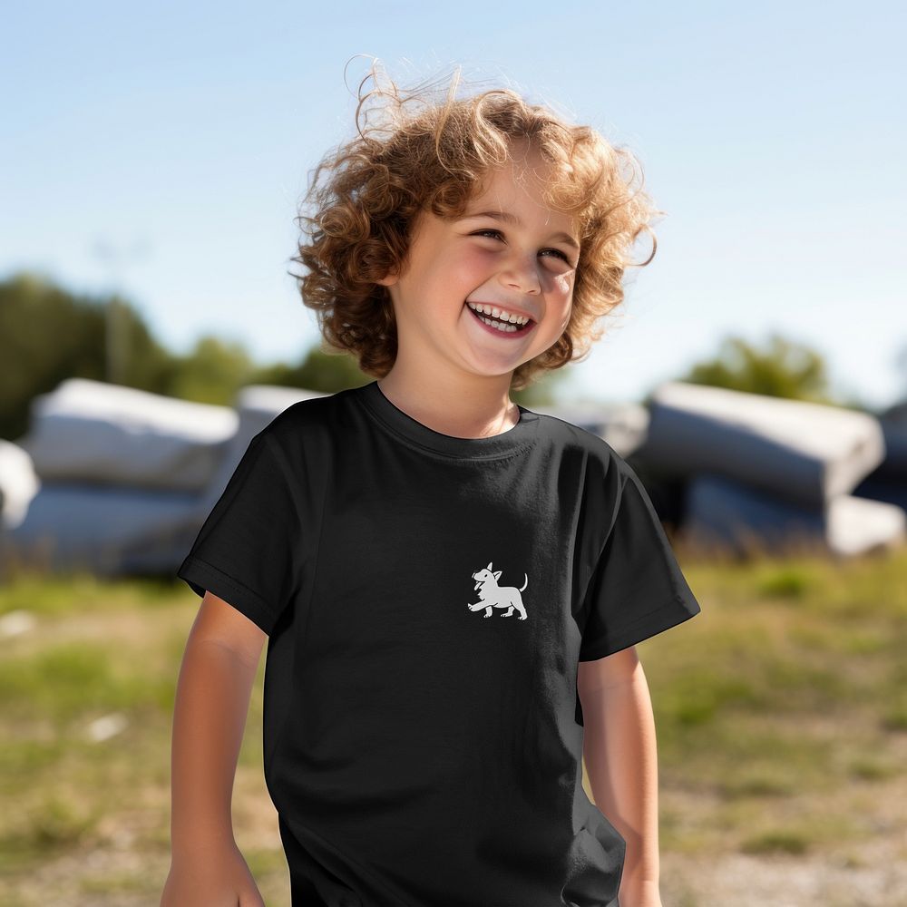 Happy blond boy in black t-shirt in park