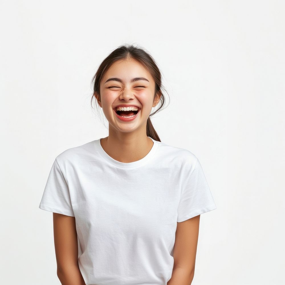 A happy young Asian woman in a white t-shirt laughing background clothing expression.