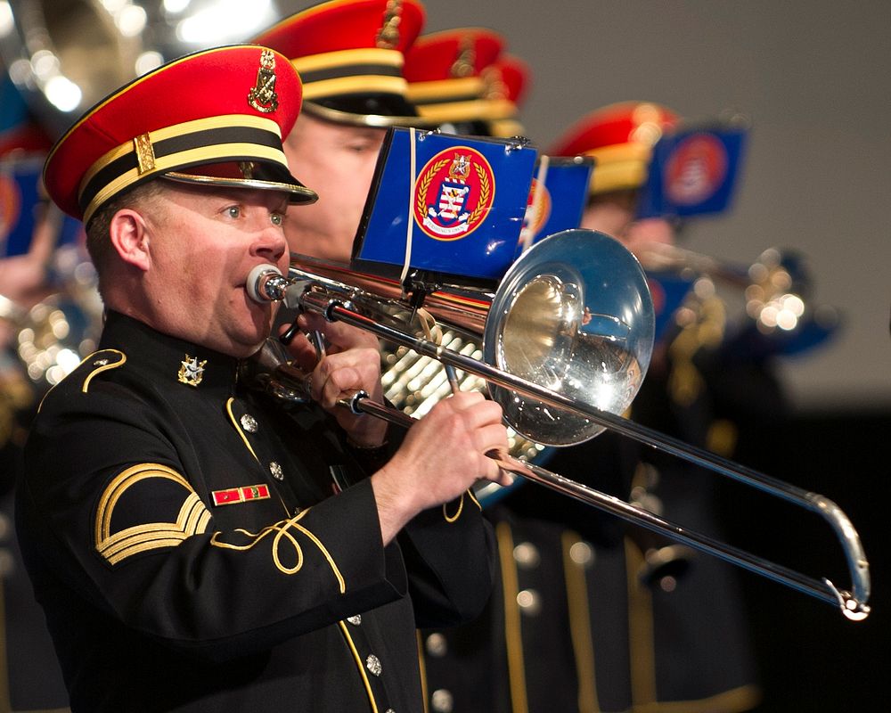 A U.S. Army Band trombone player with the "Pershing's Own" plays the national anthem at the armed forces farewell tribute in…