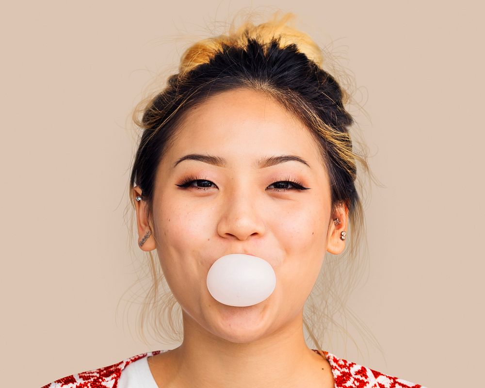 Woman blowing bubblegum, cheerful face portrait