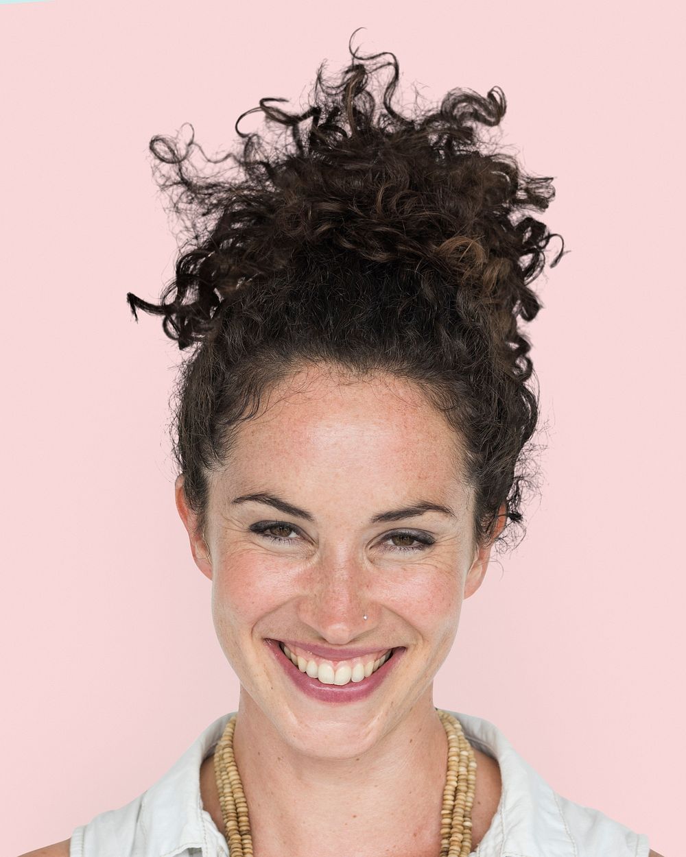 Curly haired woman portrait, smiling face close up
