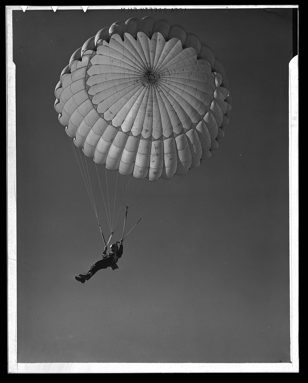 Fort Benning. Parachute troops. Look at that boy come, riding a chute like an oldtimer. A student paratrooper at Fort…