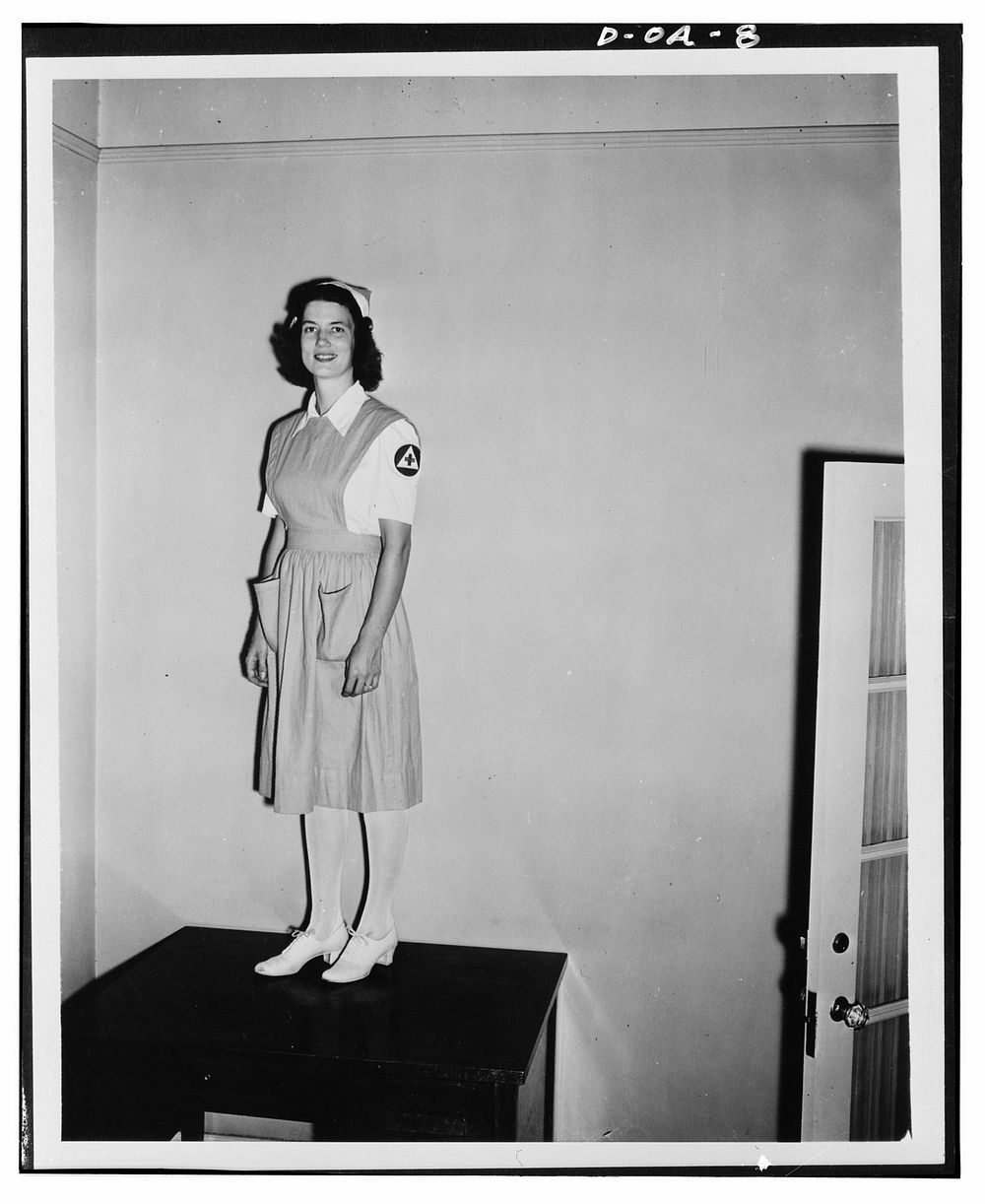 Jane Womack models new uniform selected for 100,000 defense volunteers to be trained as nurse's aides by the American Red…