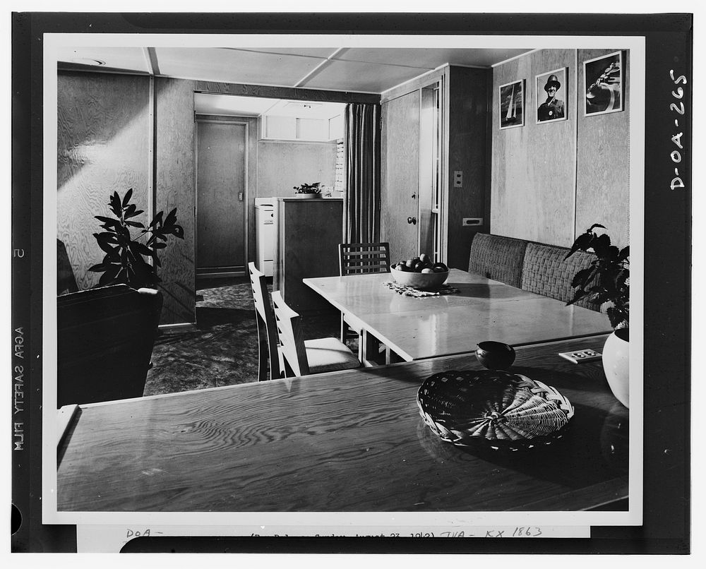 An interior of the Tennessee Valley Authority (TVA) experimental trailer-house, looking through the living-dining room into…